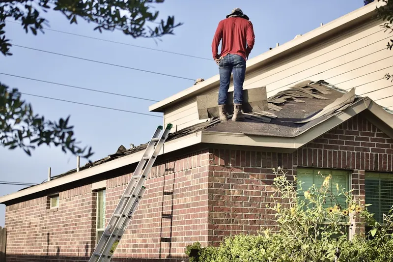 Professional roofer working on a residential roof in Brier Hill